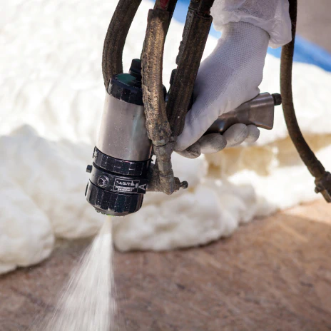 service 1 close up shot worker spraying foam insulation using plural component spray gun component